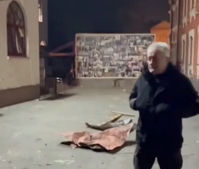 A frame from a video that shows the wreckage of a drone in a courtyard immediately next to a synagogue in Kyiv