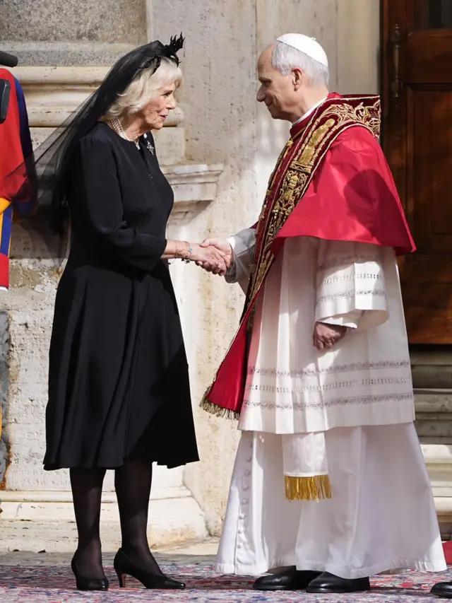 Camilla shakes hands with Pope Leo.
