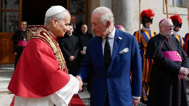 Pope Leo XIV shakes hands with King Charles following a historic prayer service