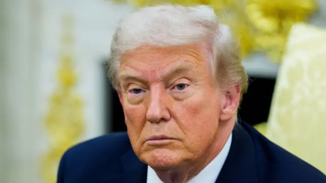 A close up of Donald Trump in the Oval Office