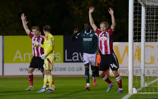 Disallowed goal for Brendan Wiredu of Plymouth Argyle as Ilmari Niskanen of Exeter City appeals for the offside