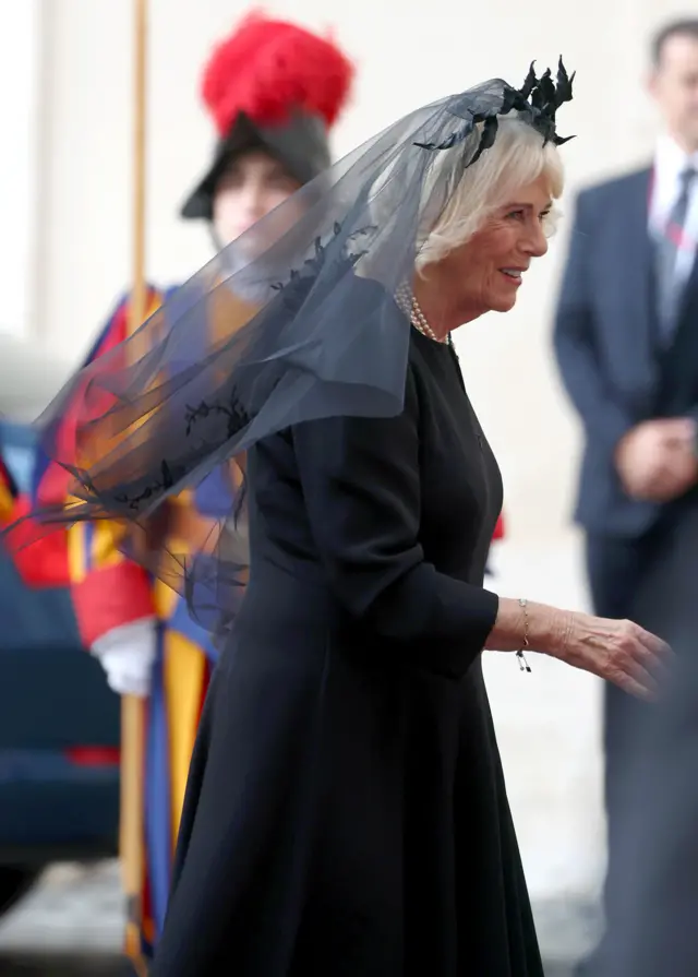 A side shot of Queen Camilla dressed in black with a black veil