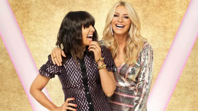 Claudia Winkleman and Tess Daly in shiny dresses smiling