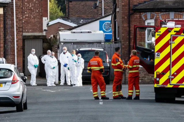 Emergency services workers near the scene in Hart Street, Southport, after the attack