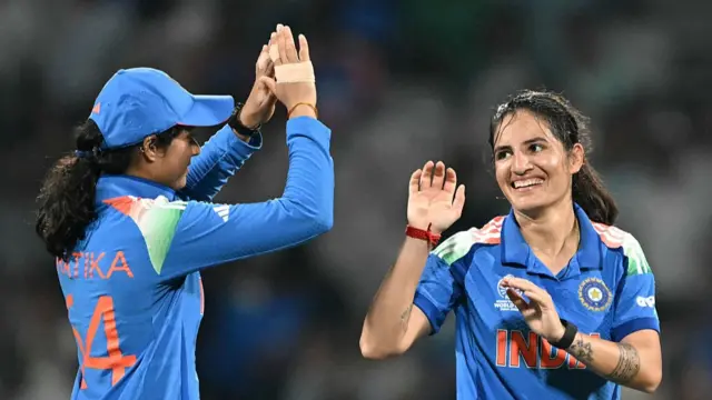 India's Renuka Singh (R) c