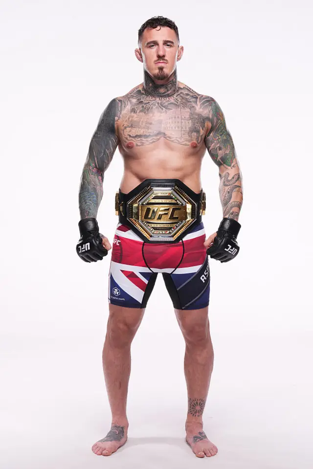 Tom Aspinall wearing the UFC heavyweight title around his waist