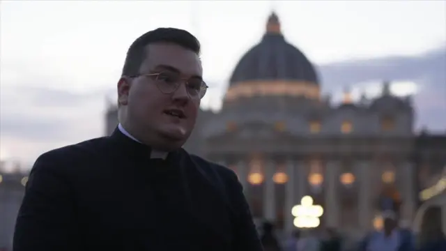 Father Robert Dykes stands in low light in St Peter's Square