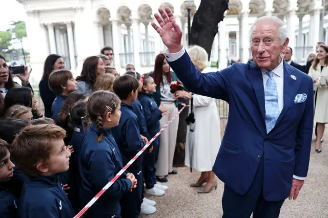 King Charles waves to children