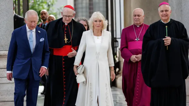 Camilla and Charles walk into the basilica
