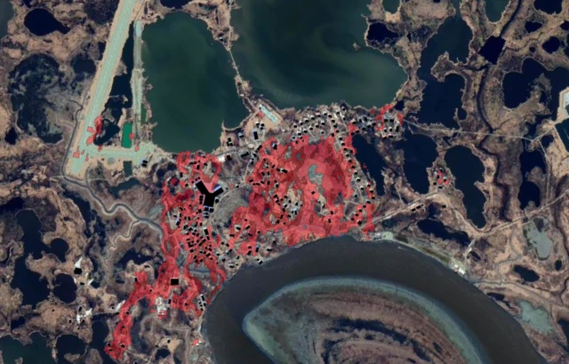 A satellite image where the greater the damage to the building the red pixels are darker