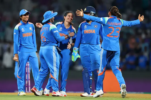 Renuka Singh of India celebrates with team mates after taking the wicket of Sophie Devine of New Zealand