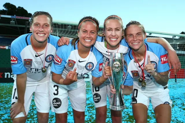 Rebekah Stott, Lauren Barnes, Beverly Yanez and Jess Fishlock of Melbourne City pose with the trophy after winning the 2017 W-League Grand Final against Perth Glory