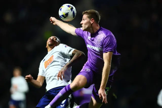 Mark McGuinness of Sheffield United handles in the penalty area with Daniel Jebbison of Preston North End