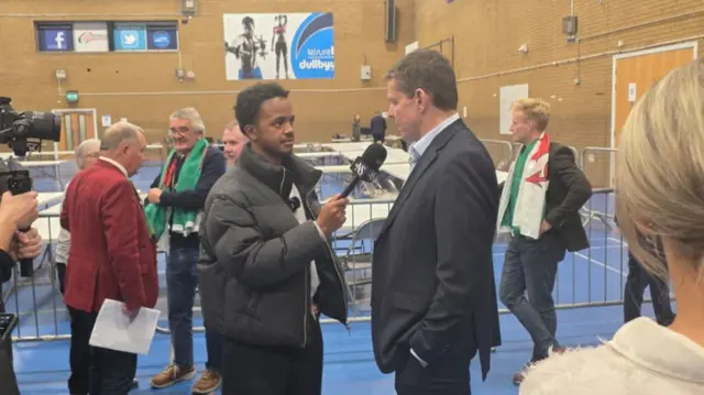 Rhun ap Iorwerth speaking to a journalist