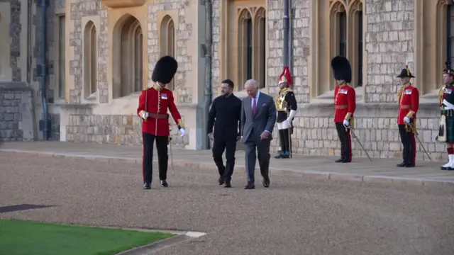 Zelensky and the King chat with the head of the guard as they prepare to inspect them