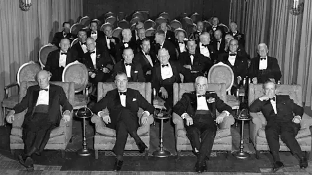 President Dwight Eisenhower and guests sitting in the small private cinema for use by the first family that is located in the East Wing
