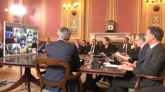 Leaders sit around a table