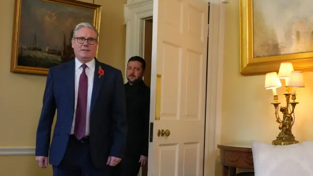 Keir Starmer enters a yellow room insider Number 10 followed by Volodymyr Zelensky