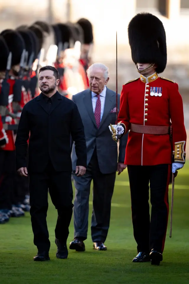 Zelesnky walks in front of the King while inspecting troops