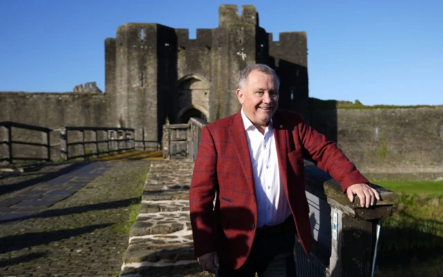 Plaid Cymru's newly elected Senedd member Lindsay Whittle in front of Caerphilly Castle
