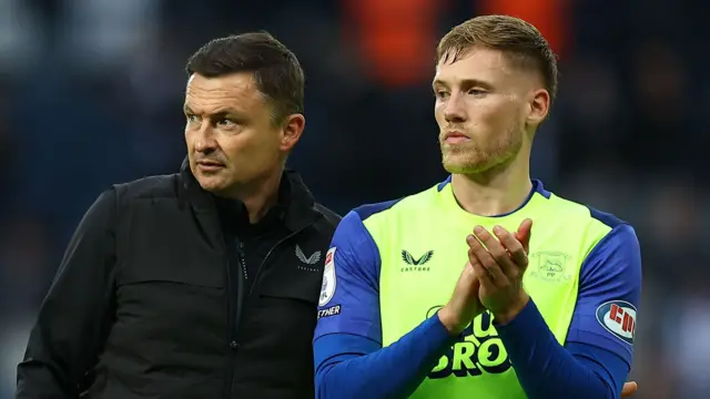 Lewis Gibson applauds the Preston fans with Paul Heckingbottom