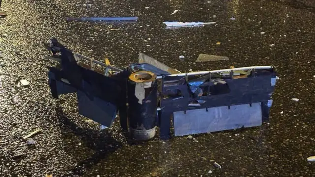 Drone debris on the ground near the apartment block