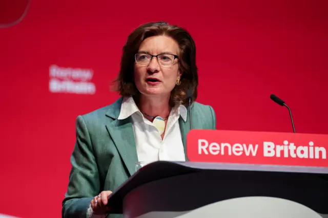 Eluned Morgan at the podium of the the annual Labour Party conference