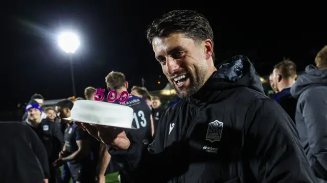 Adam Hastings with cake