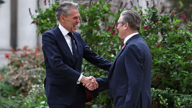 Dick Schoof grins as he shakes hands with Keir Starmer as he arrives to the Foreign office