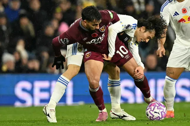 Lucas Paqueta (L) holds off the challenge
