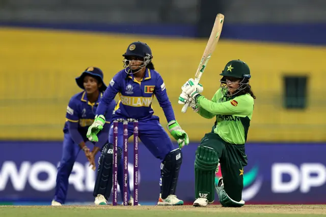 Muneeba Ali of Pakistan bats as wicket keeper Anushka Sanjeewani of Sri Lanka looks on