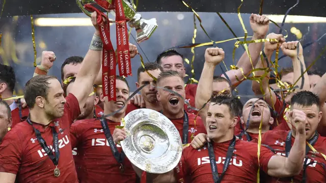Wales' lock Alun Wyn Jones (L) holds up the trophy after being crowned Six Nations rugby champions after beating Ireland at the Principality Stadium in Cardiff, south Wales, on March 16, 2019