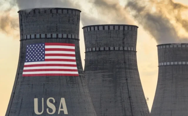 Three energy smokestacks with a US flag on one