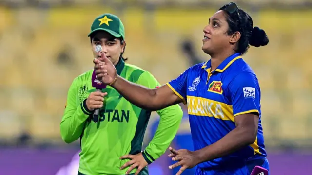 Sri Lanka's captain Chamari Athapaththu (R) tosses the coin as her Pakistan's counterpart Fatima Sana looks on