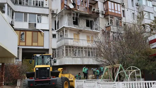 Damage removal operations outside a residential building struck in overnight attacks in Kherson
