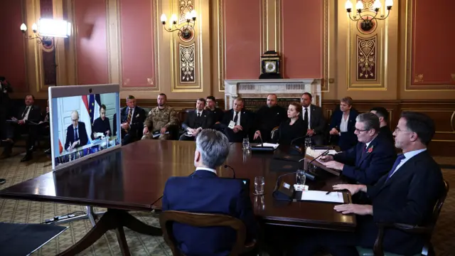 British Prime Minister Keir Starmer is flanked by Ukraine's President Volodymyr Zelensky, NATO Secretary-General Mark Rutte, Denmark's Prime Minister Mette Frederiksen and Dutch Prime Minister Dick Schoof facing a screen with other participants