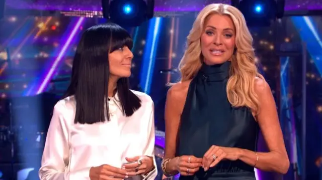 Claudia Winkelman wears a white shirt and Tess Daly wears a sleeveless green dress