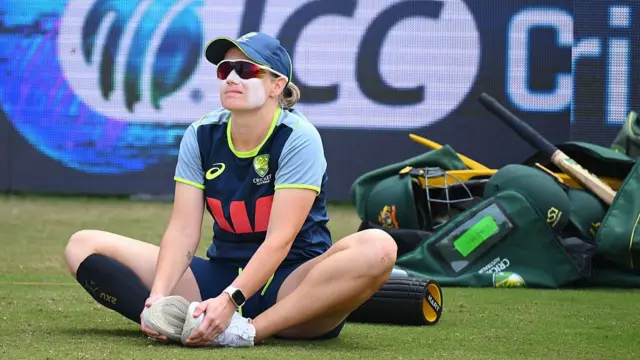 Alyssa Healy sat on the ground