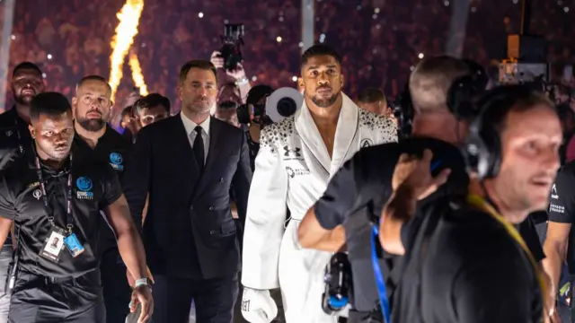 Anthony Joshua and Eddie Hearn walk to the ring