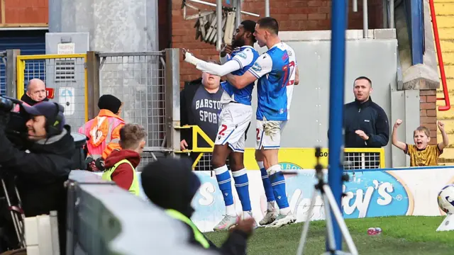 Ryan Alebiosu celebrates in front of the Blackburn fans