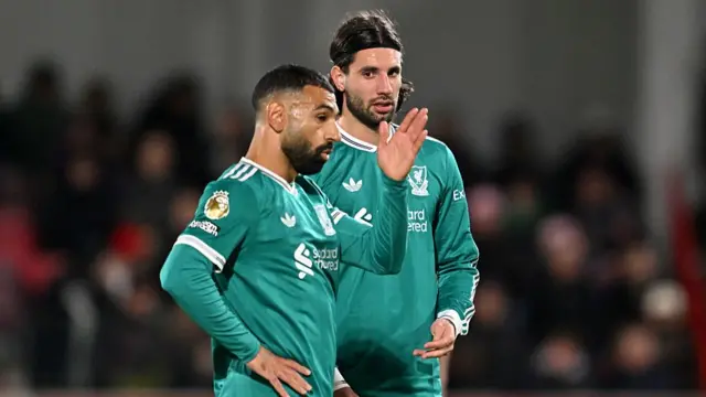 Dominik Szoboszlai speaks with teammate Mohamed Salah