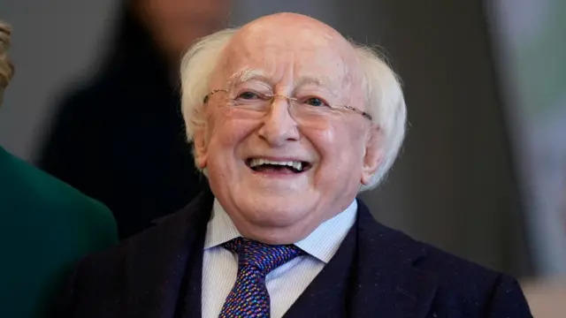 Ireland's President Michael D Higgins, pictured from the chest up. He is wearing a tie, blue shirt and navy jacket.