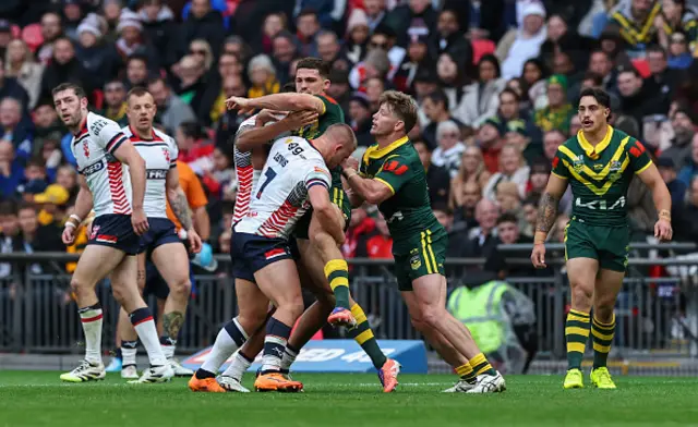 Australia's Nathan Cleary is tackled by England's Mikey Lewis and Kai Pearce-Paul with Harry Grant