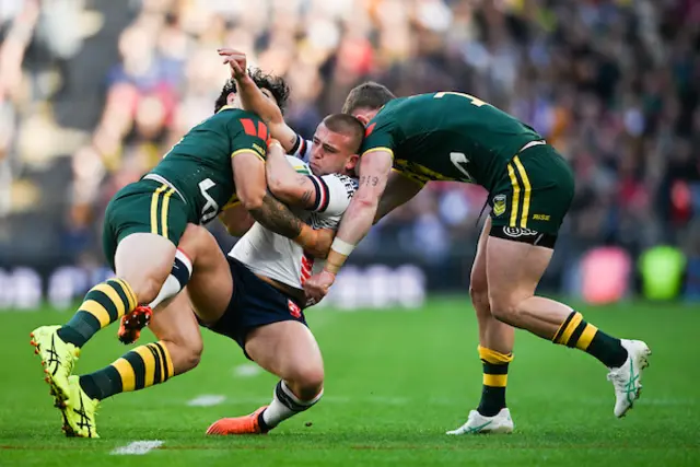 Mikey Lewis of England is tackled by Australia