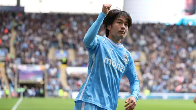 Tatsuhiro Sakamoto raises his fist in celebration