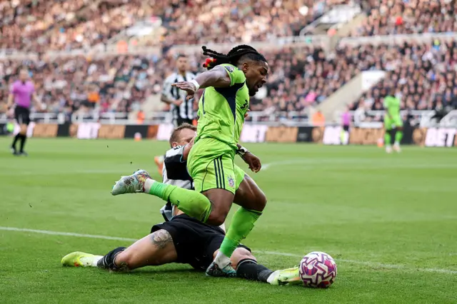 Adama Traore of Fulham is challenged by Dan Burn