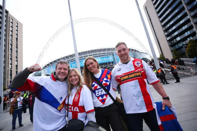 Fans outside Wembley pose