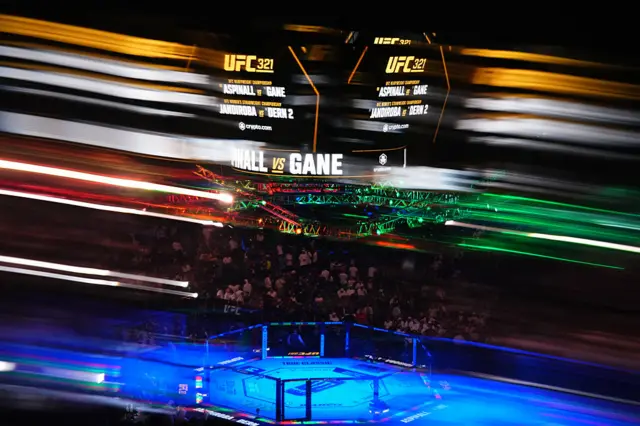 A general view of the UFC octagon underneath a large screen displaying 'Aspinall v Gane' and Jandiroba v Dern 2'