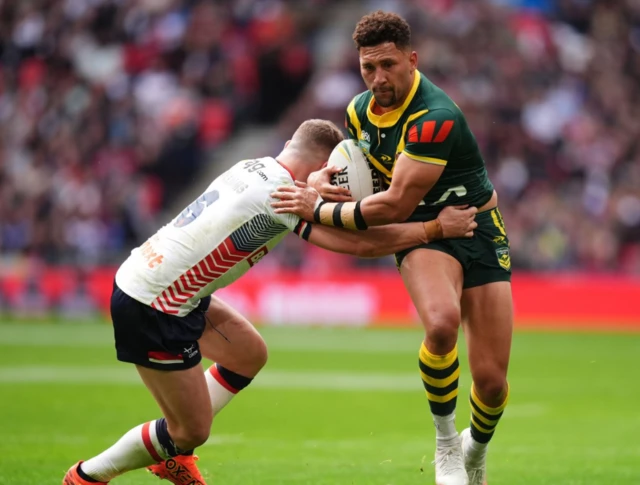 Australia's Gehamat Shibasaki is tackled by George Williams
