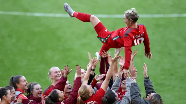 Jess Fishlock thrown in the air by players